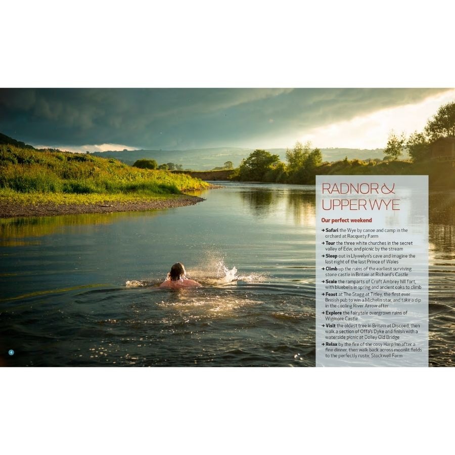 Person swimming in a river under a cloudy sky, with sunlight on surrounding greenery.